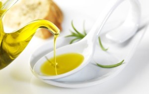 virgin olive oil pouring in a spoon
